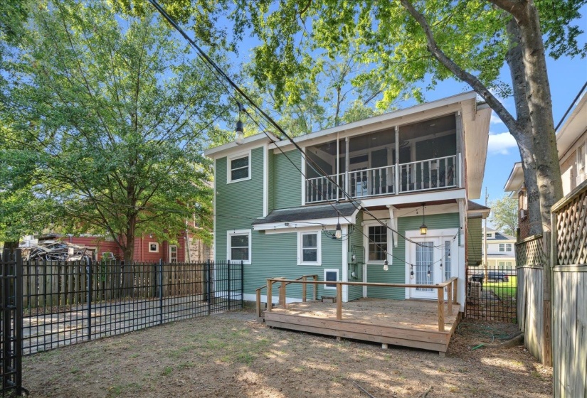 Rear view of property with a sunroom
