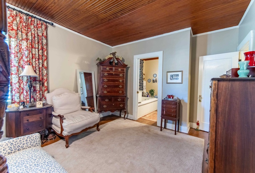 Living area featuring ornamental molding and wooden ceiling