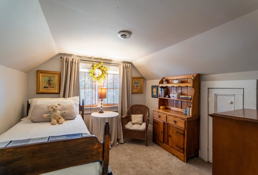 Carpeted bedroom with lofted ceiling