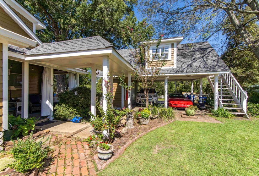 View of yard featuring a carport and covered porch
