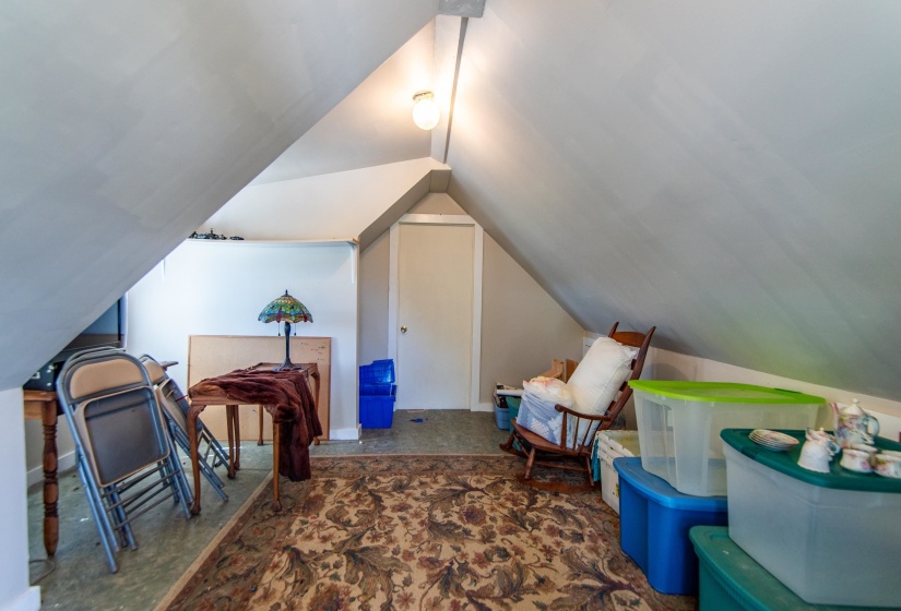 Interior space featuring lofted ceiling and dark colored carpet