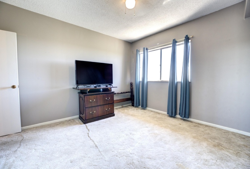 Carpeted bedroom with a textured ceiling