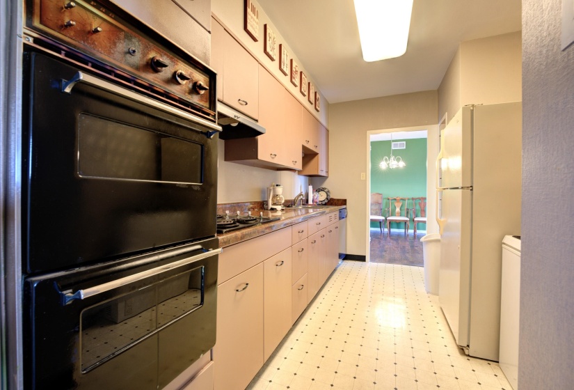 Kitchen featuring appliances with stainless steel finishes, white cabinetry, and sink