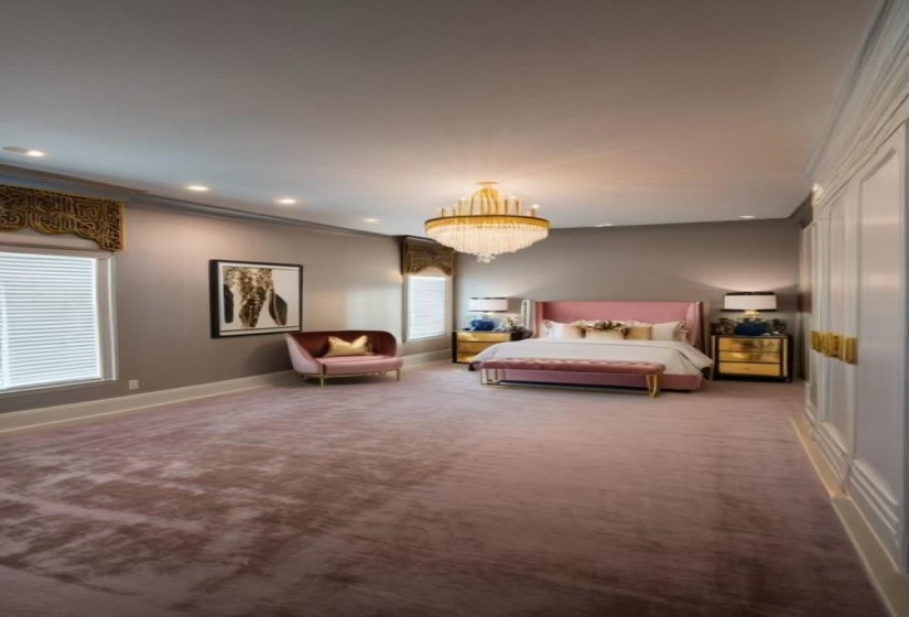 Unfurnished bedroom with crown molding, carpet floors, and an inviting chandelier
