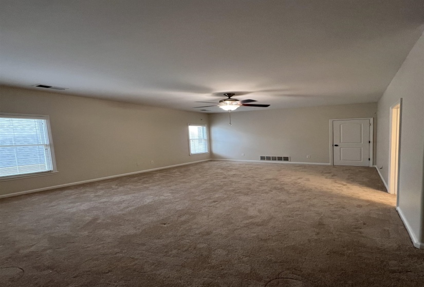 Empty room with carpet and ceiling fan