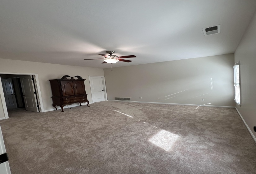 Unfurnished bedroom featuring carpet flooring and ceiling fan
