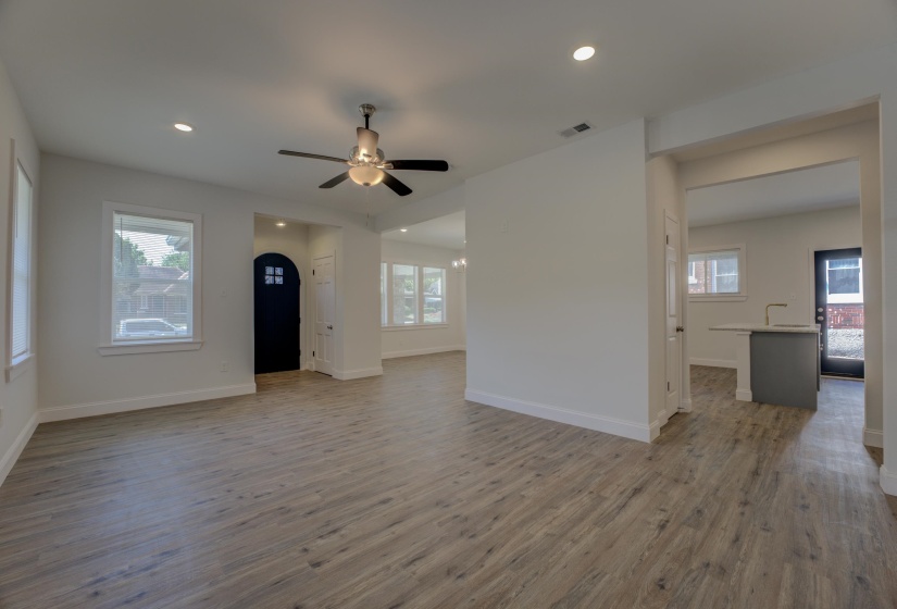 Unfurnished living room featuring ceiling fan and hardwood / wood-style flooring