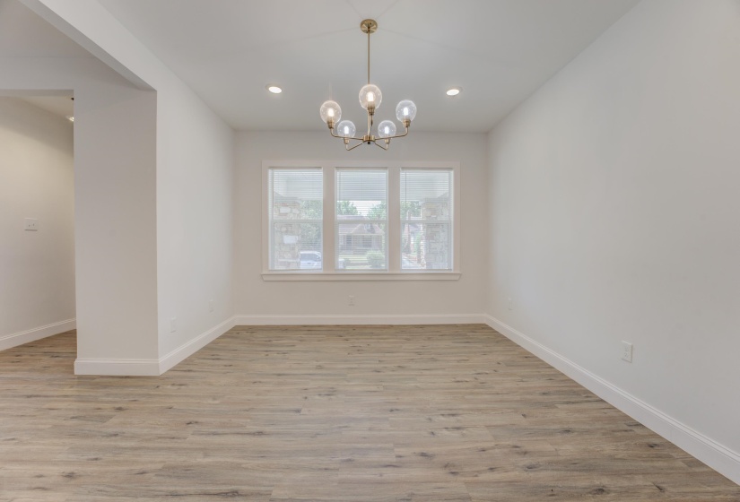 Unfurnished dining area with light hardwood / wood-style flooring and a chandelier