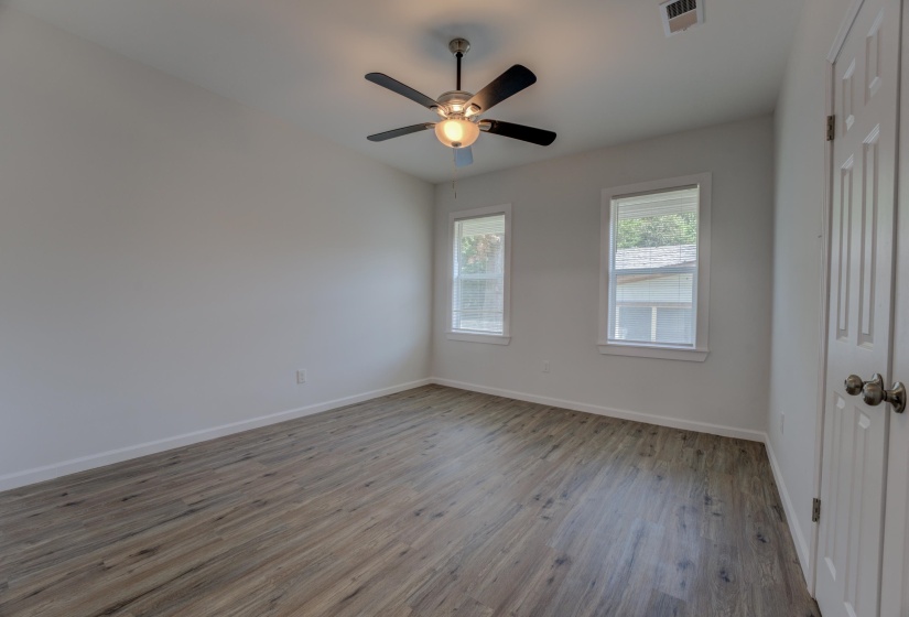 Spare room with ceiling fan and wood-type flooring