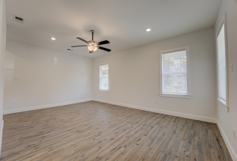 Empty room featuring ceiling fan and light hardwood / wood-style flooring