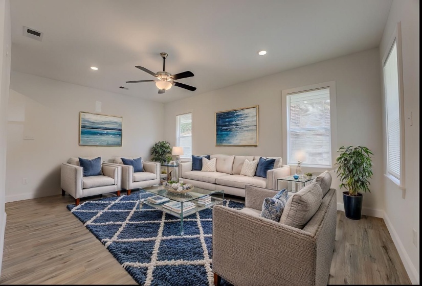 Living room featuring ceiling fan and light wood-type flooring