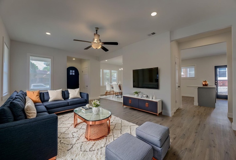 Living room with ceiling fan, hardwood / wood-style floors, and a wealth of natural light