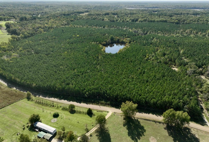 Birds eye view of property with a water view and a rural view