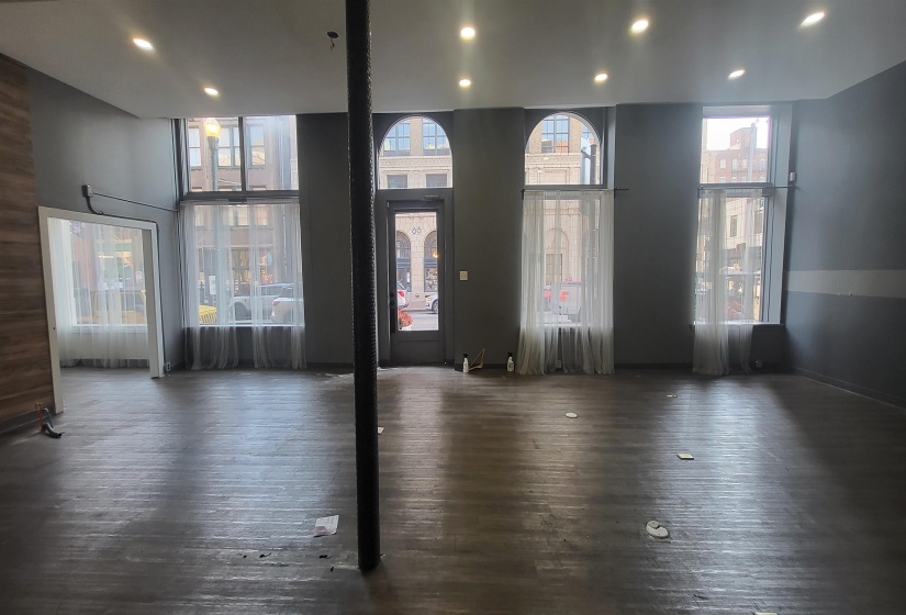 Interior space with a towering ceiling and dark wood-type flooring