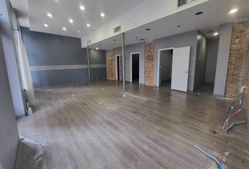 Spare room featuring hardwood / wood-style floors and a towering ceiling