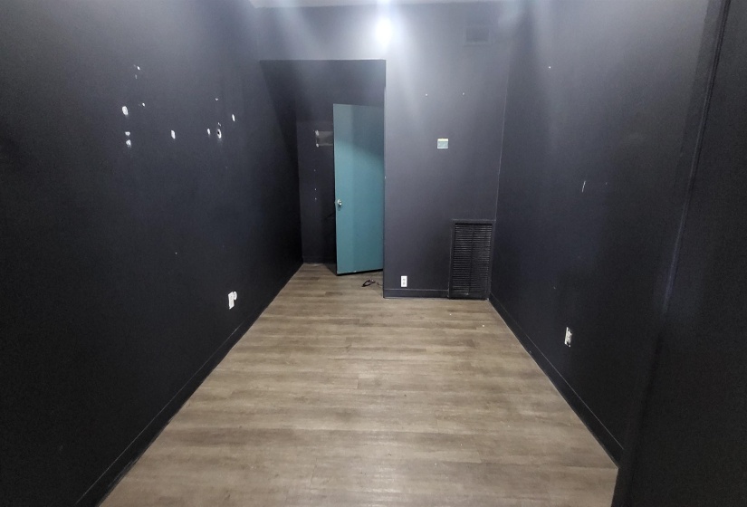 Empty room with light hardwood / wood-style flooring