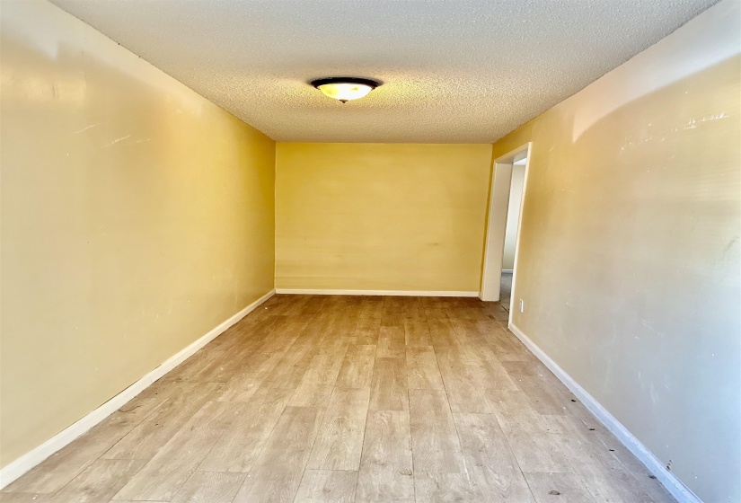 Empty room featuring light hardwood / wood-style flooring and a textured ceiling