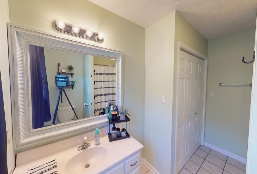 Bathroom featuring vanity, a textured ceiling, and tile patterned flooring