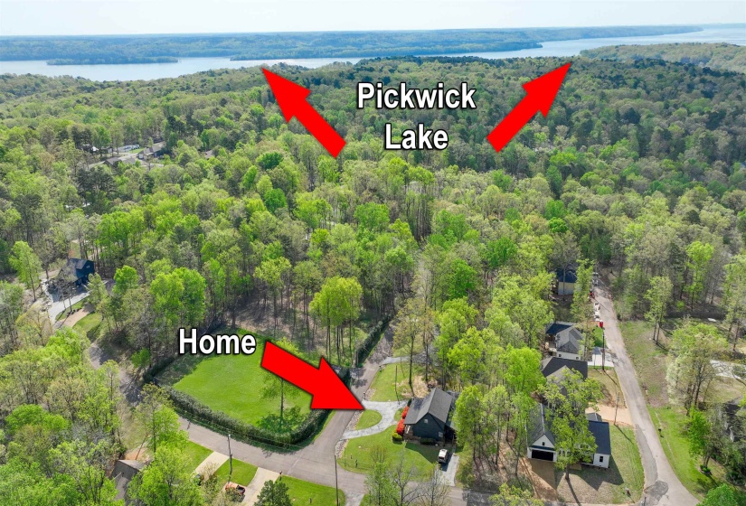 Bird's eye view featuring a wooded view and a water view