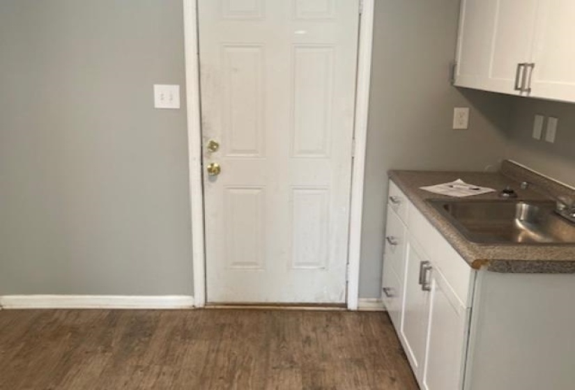 Washroom featuring sink and dark hardwood / wood-style floors