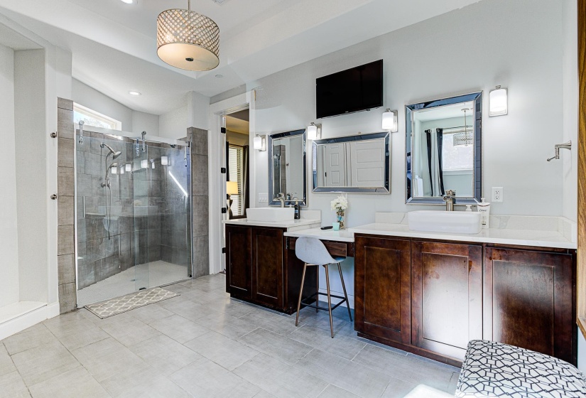 Bathroom with vanity, an enclosed shower, and tile patterned floors