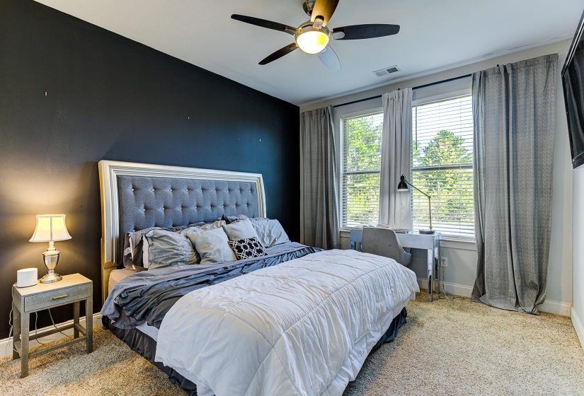 Carpeted bedroom with ceiling fan