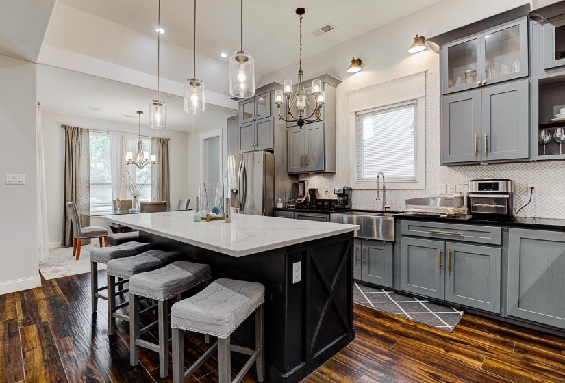Kitchen with gray cabinetry, dark wood-type flooring, and pendant lighting
