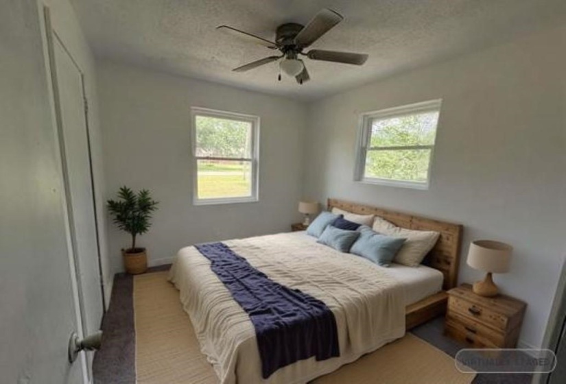 Bedroom featuring a textured ceiling and a ceiling fan