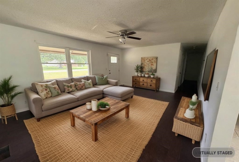 Living room featuring a textured ceiling and a ceiling fan