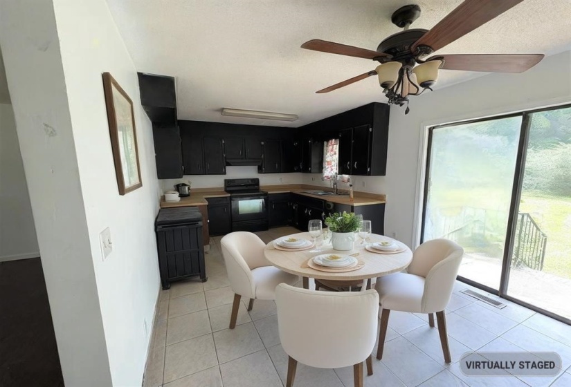 Dining space with light tile patterned floors and a ceiling fan