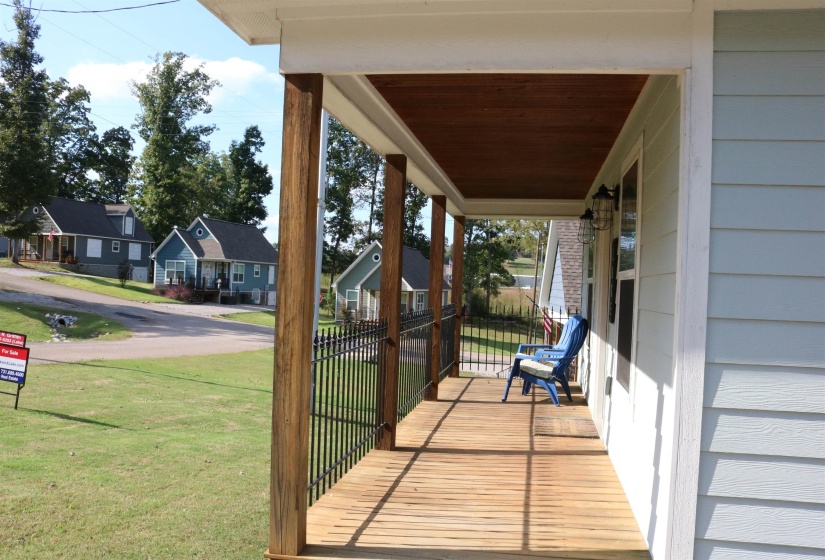 Wooden terrace with a porch and a yard