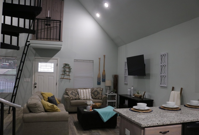 Living room featuring high vaulted ceiling