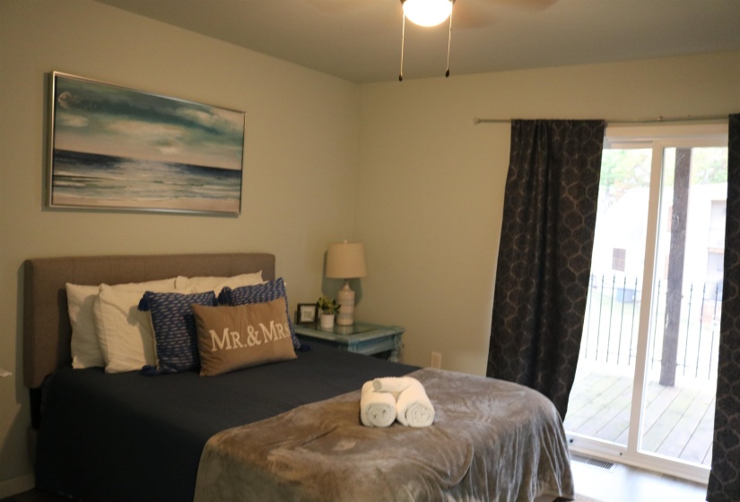 Bedroom with ceiling fan and access to exterior
