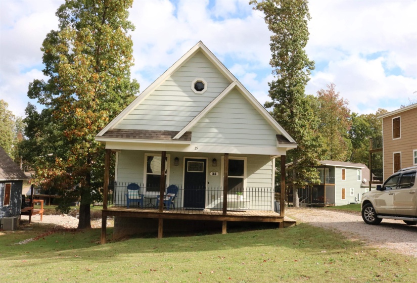 View of front facade with covered porch and a front lawn