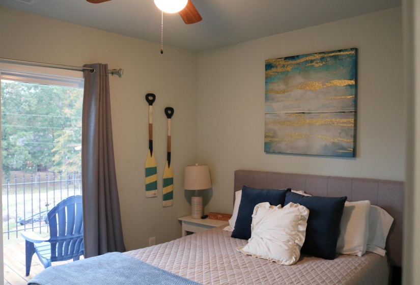 Bedroom with ceiling fan and access to outside