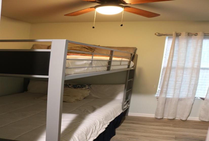 Bedroom featuring hardwood / wood-style flooring and ceiling fan