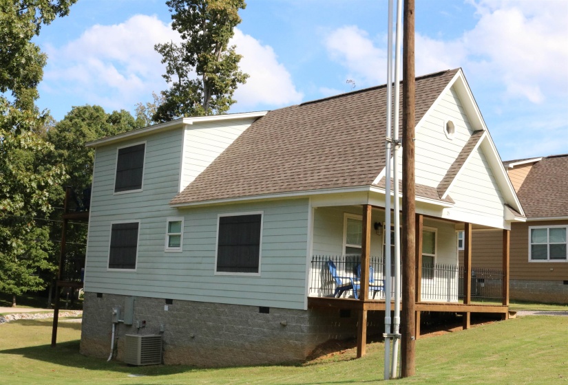 Back of house with cooling unit and a yard