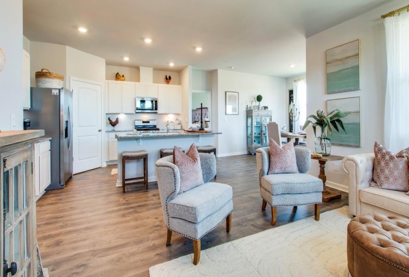 Living room with a fireplace and light wood-type flooring