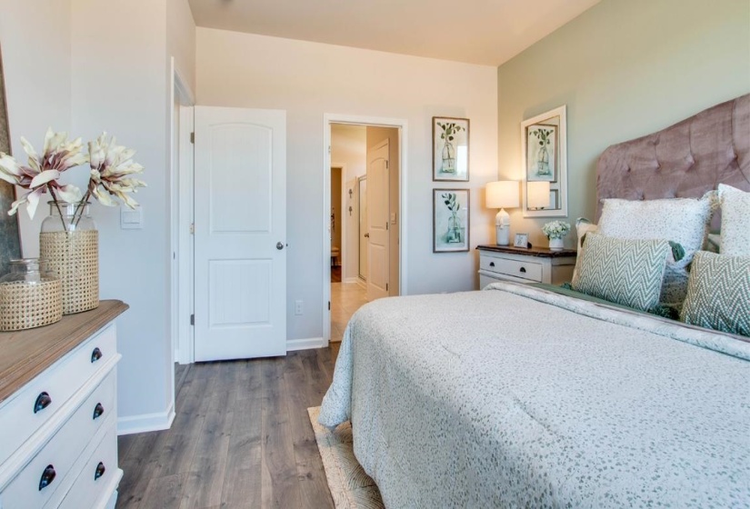 Bedroom with dark hardwood / wood-style flooring