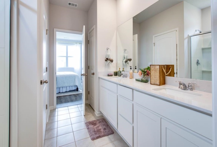 Bathroom with vanity, tile patterned floors, and walk in shower