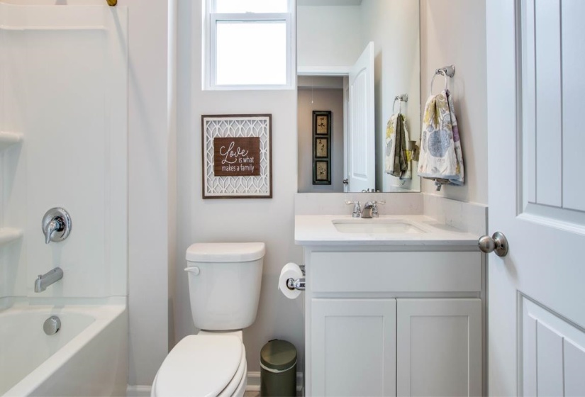 Full bathroom with vanity,  shower combination, and toilet