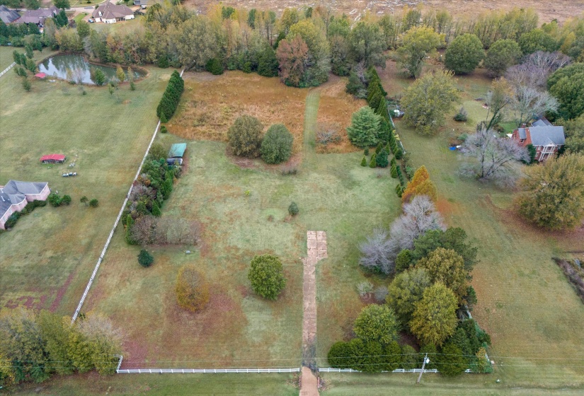 Birds eye view of property with a rural view and a water view