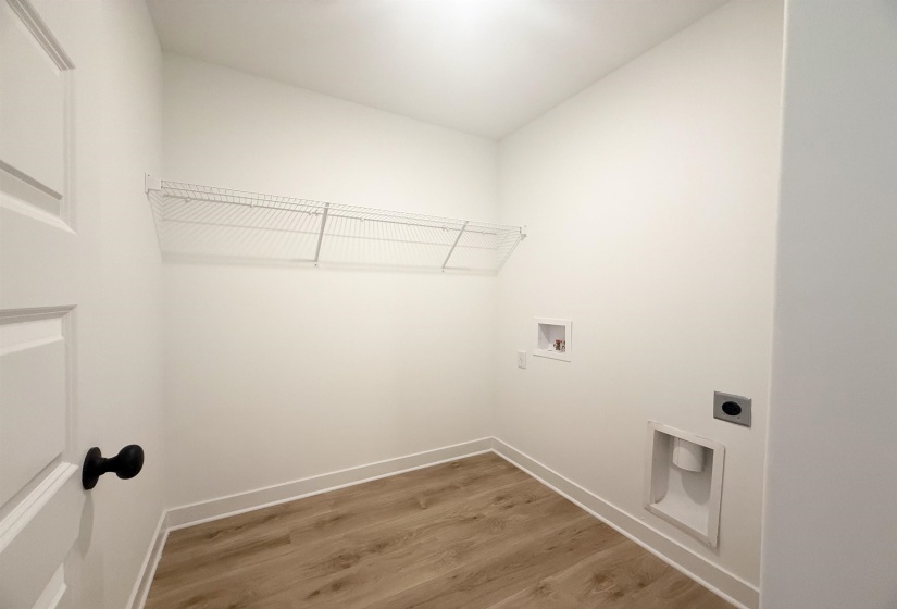 Washroom with hookup for an electric dryer, washer hookup, and light wood-style floors