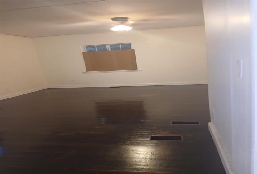 Unfurnished room featuring dark hardwood / wood-style flooring