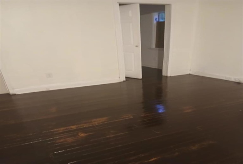 Spare room featuring dark wood-type flooring