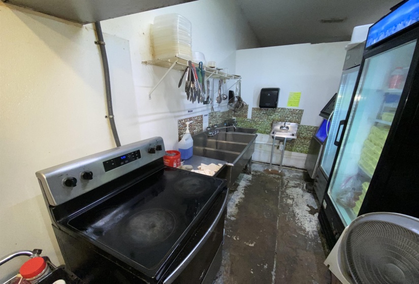 Kitchen with black range with electric cooktop