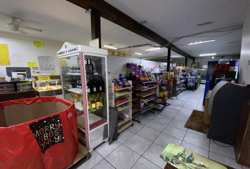 Miscellaneous room featuring beam ceiling, ceiling fan, and light tile patterned flooring