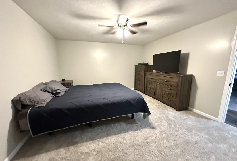 Bedroom featuring ceiling fan and light colored carpet