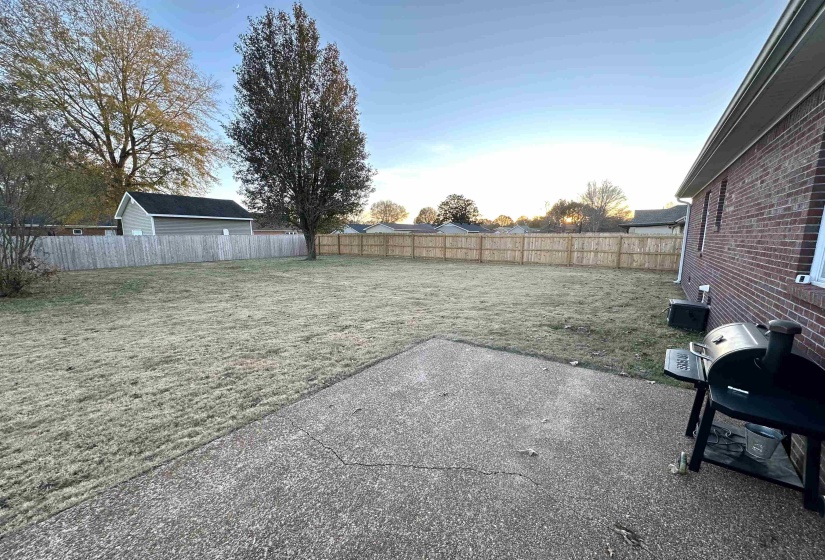 Yard at dusk with a patio area