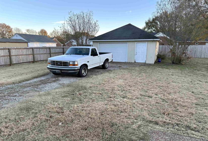 Garage featuring a lawn